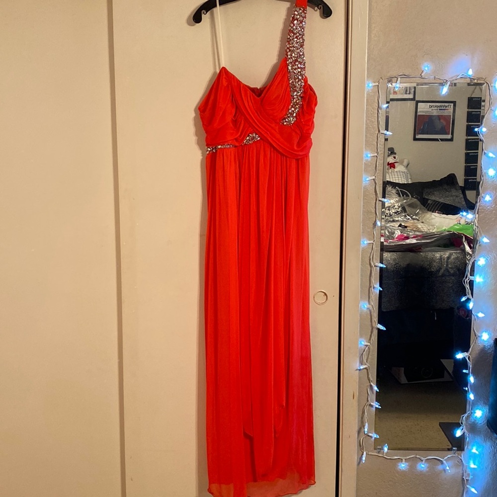 Long formal dress, it’s reddish/pink.